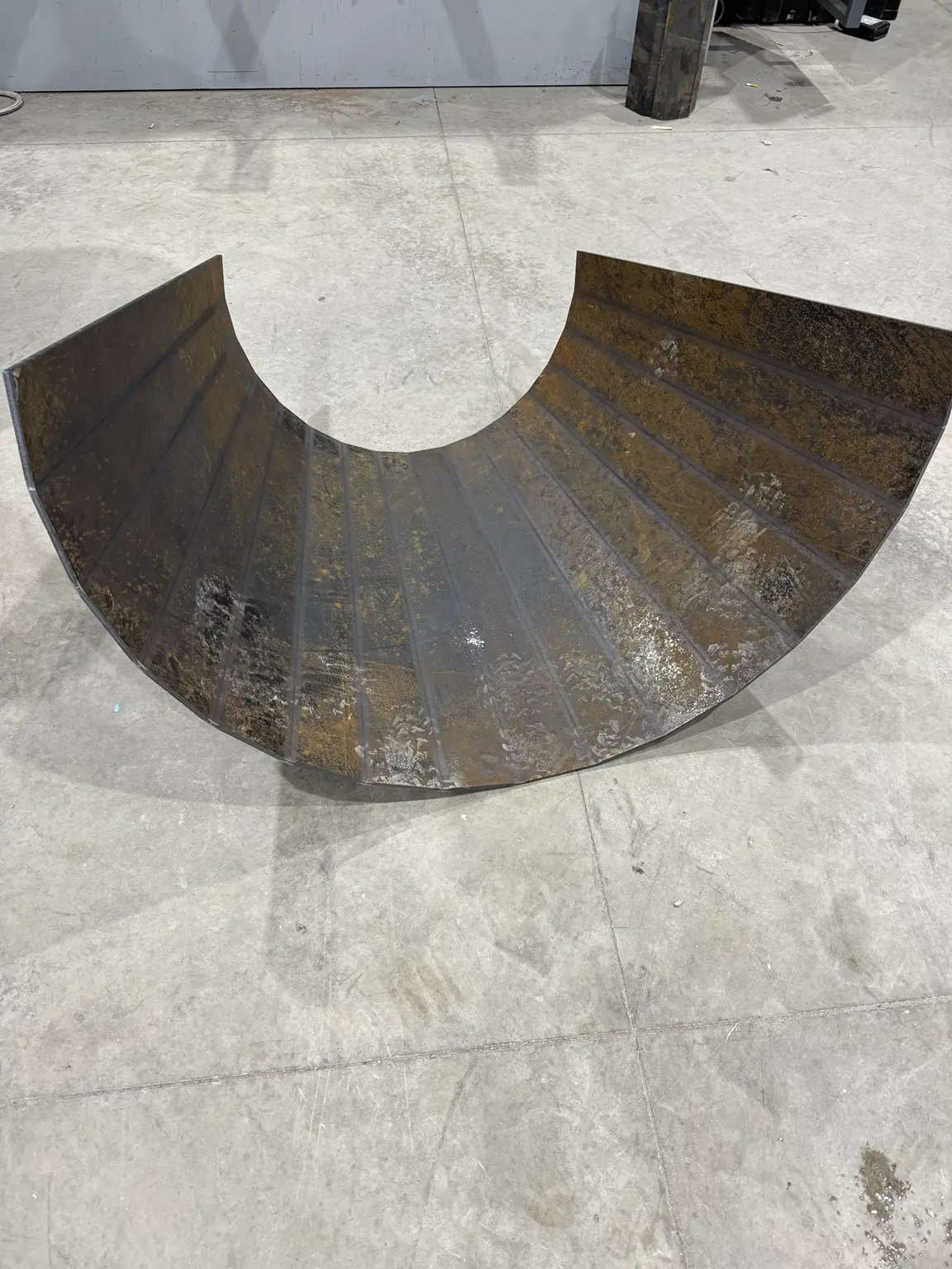 Laser-cut steel plate formed into a cone section
