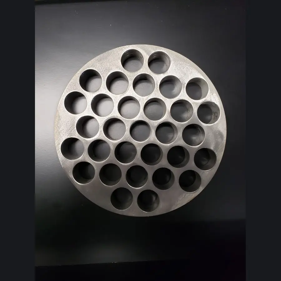 Circular custom-cut plate with a repeated hole pattern